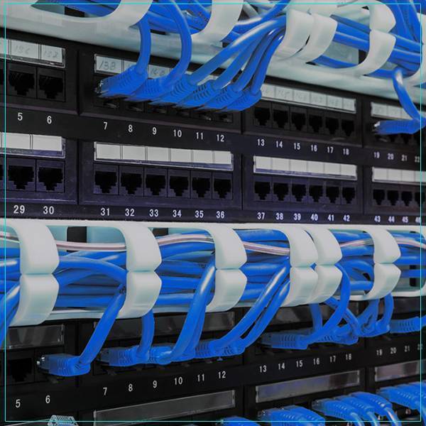a rack of blue wires in a data center.