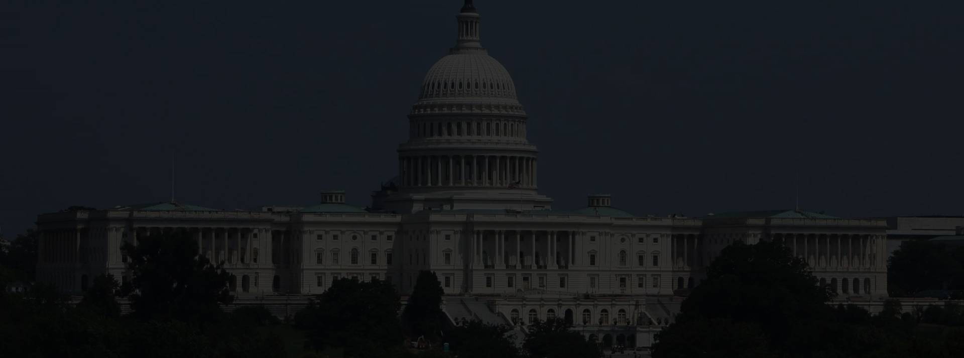 the united states capitol building is lit up at night.