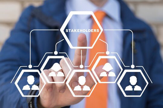 A person in business attire points to a virtual diagram showing interconnected hexagons labeled "Stakeholders" and icons representing people.