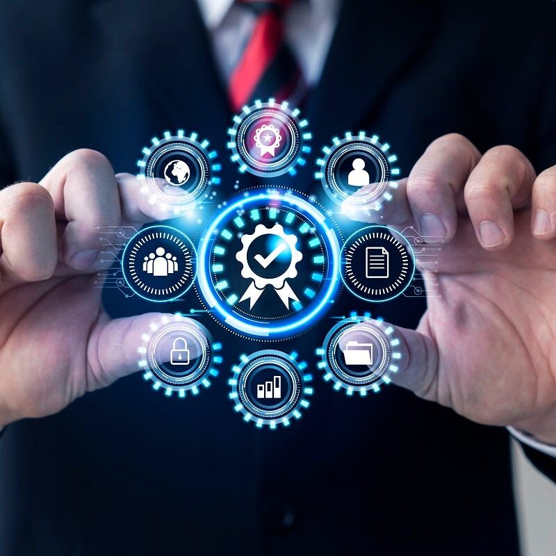 A person in a suit touches a digital interface with icons representing business concepts such as certification, data, security, and communication.