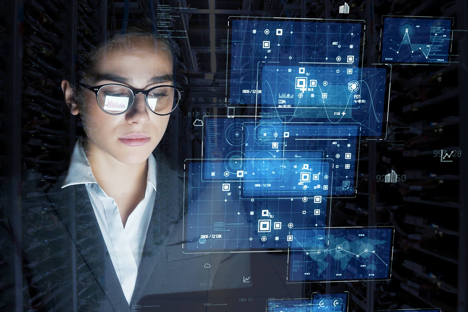 A woman in business attire looks at virtual digital interfaces displaying data, charts, and network graphics in a technology-driven environment.