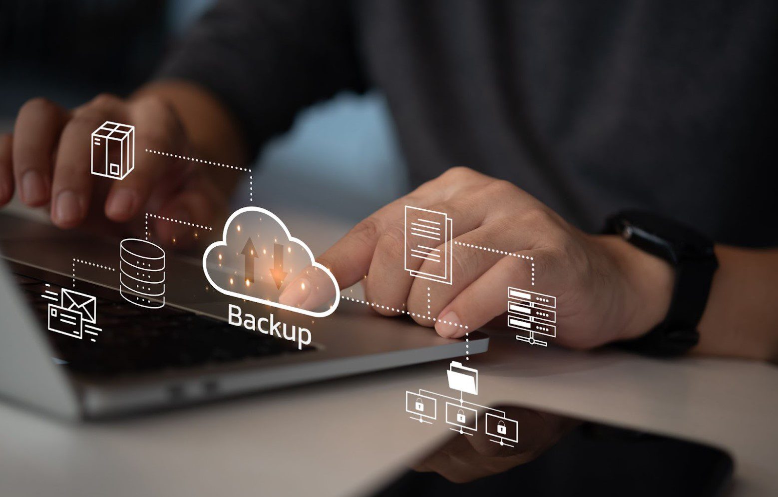 Hands typing on a laptop keyboard with virtual icons and the word "Backup" representing data backup and cloud storage technology.
