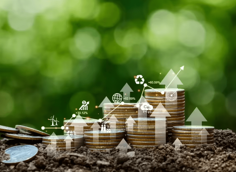 Stacks of coins on soil with illustrated financial growth and sustainability icons, symbolizing economic growth and environmental progress.